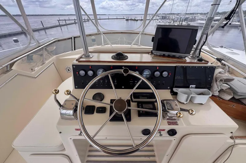 Slide: The Image of Helm of 1987 Chris-Craft 422 Commander with steering wheel and navigation equipment. - 5