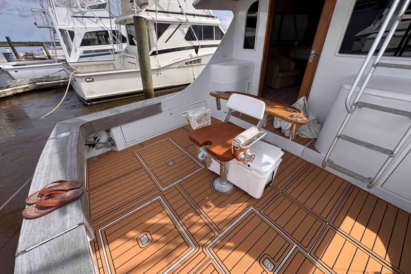 Slide: The Image of 1989 Buddy Davis 47 yacht deck with fishing chair and teak flooring. - 16