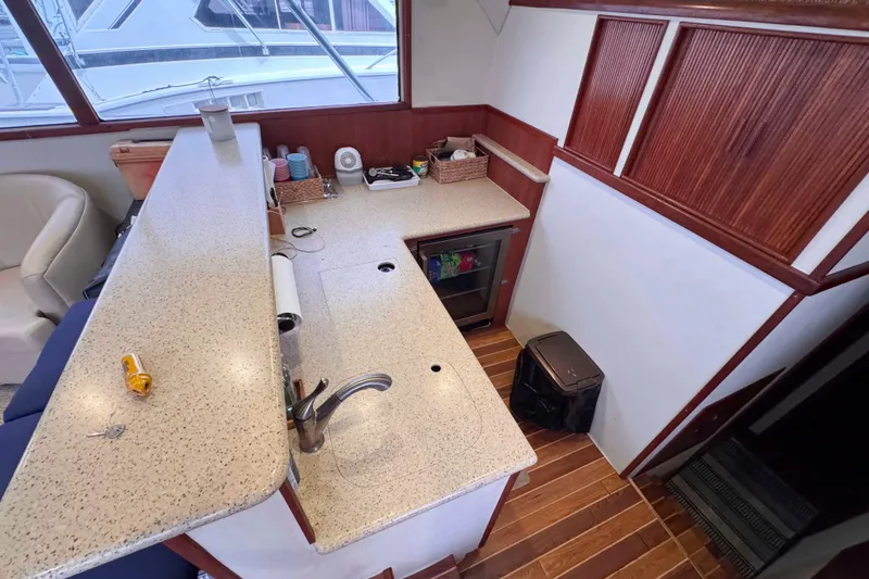 Slide: The Image of 1989 Buddy Davis 47 yacht interior with modern kitchen and wooden flooring. - 26