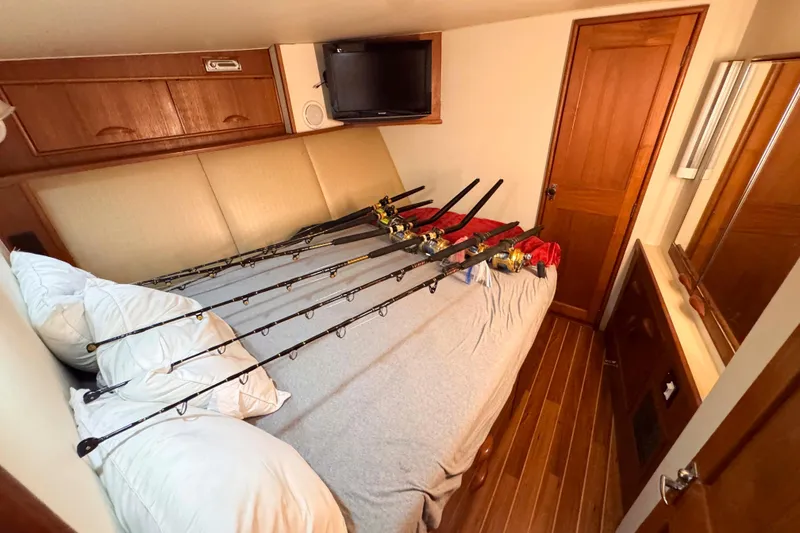 Slide: The Image of Bedroom in 1989 Buddy Davis 47 yacht with fishing rods on bed. - 27
