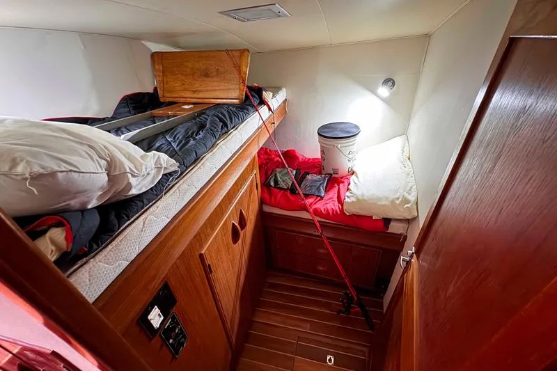 Slide: The Image of Cozy cabin interior of 1989 Buddy Davis 47 boat with bunk beds and fishing gear. - 28