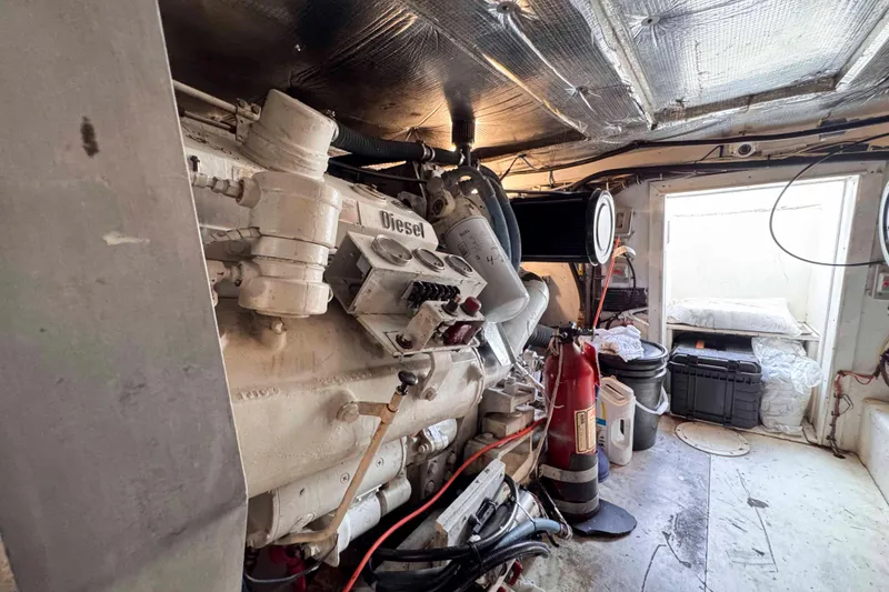 Slide: The Image of Engine room of a 1989 Buddy Davis 47 boat with diesel engine components. - 30