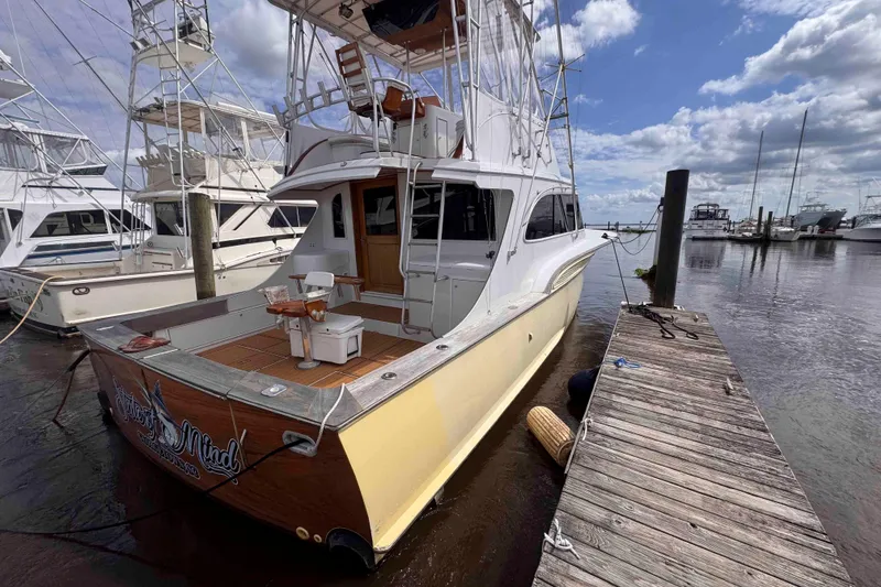Slide: The Image of 1989 Buddy Davis 47 yacht docked at marina under cloudy sky. - 4