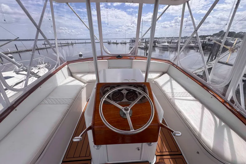 Slide: The Image of Helm of 1989 Buddy Davis 47 yacht with wooden steering wheel and panoramic marina view. - 7