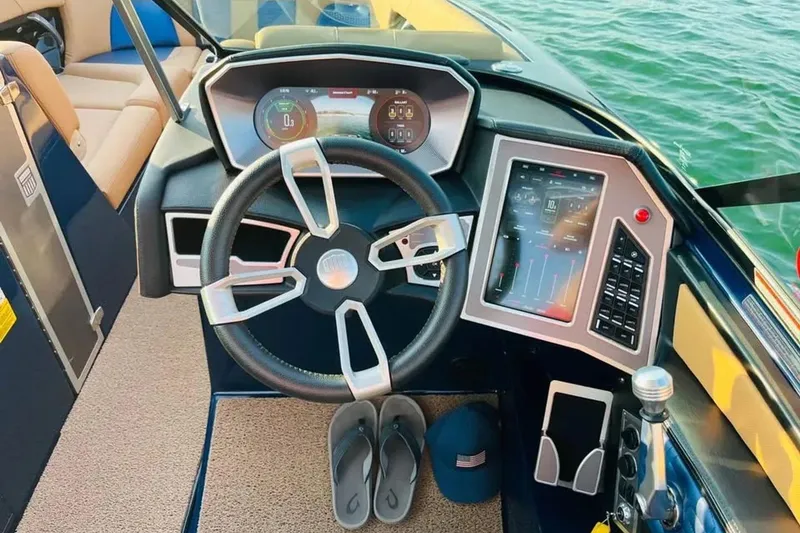 Slide: The Image of 2019 Mastercraft X26 boat dashboard with modern controls and steering wheel. - 5