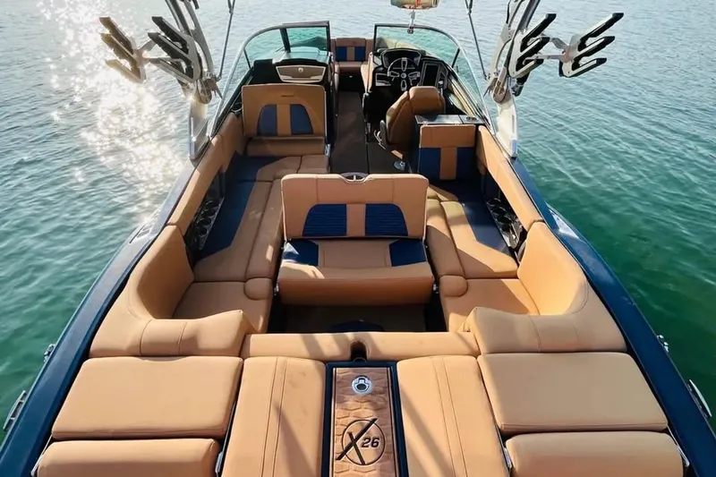 Slide: The Image of 2019 MasterCraft X26 boat interior with luxurious seating on calm water. - 7
