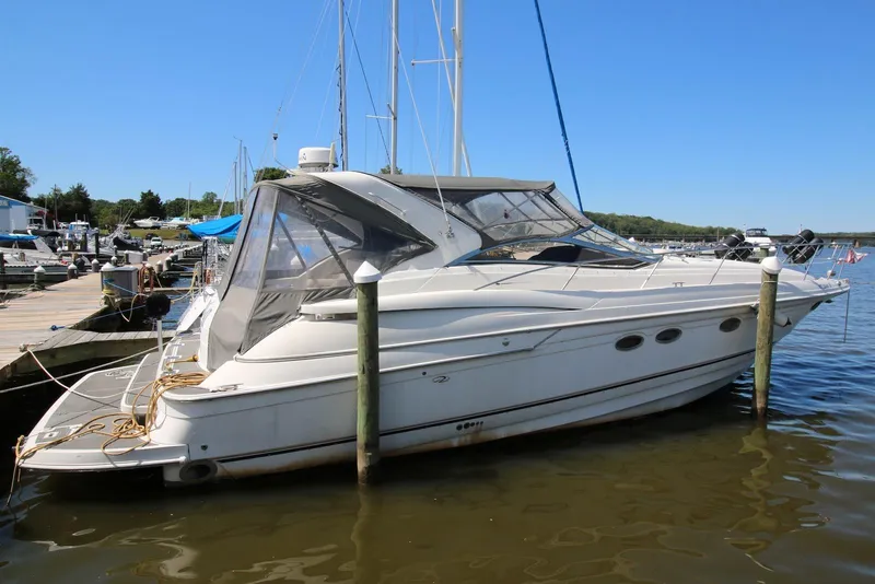 The Image of 2000 Regal Commodore 4160 yacht docked at marina under clear blue sky. - 0