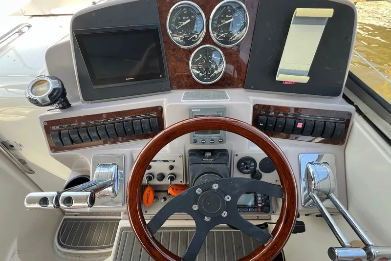 Slide: The Image of Control panel of a 2000 Regal Commodore 4160 boat with gauges and steering wheel. - 10