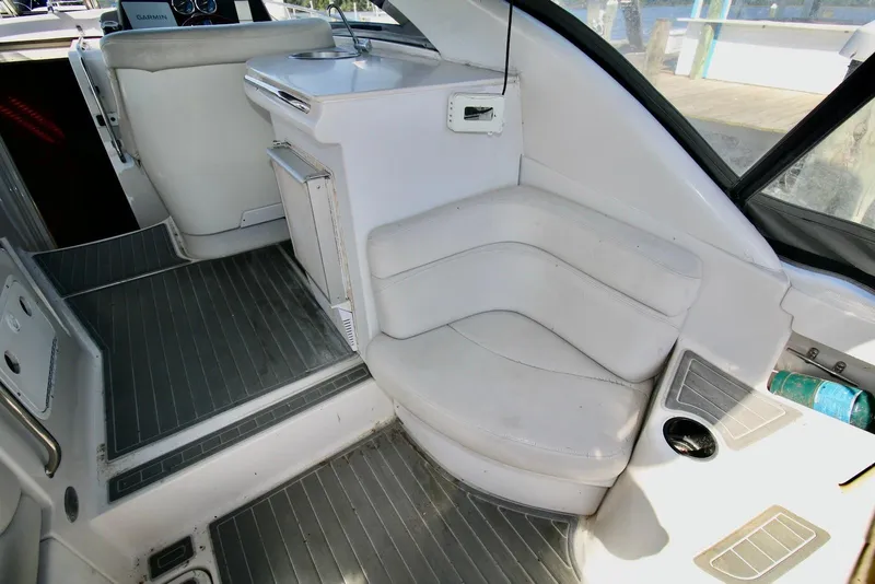 Slide: The Image of Interior of 2000 Regal Commodore 4160 boat with white seating and gray flooring. - 11
