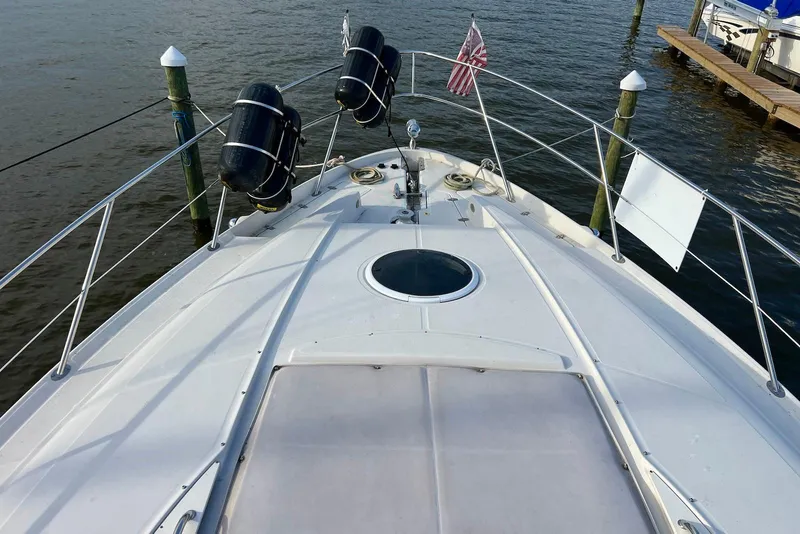 Slide: The Image of Bow view of 2000 Regal Commodore 4160 yacht docked on calm water. - 12