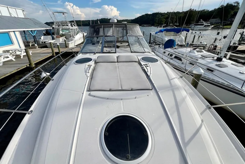Slide: The Image of 2000 Regal Commodore 4160 yacht docked at marina, featuring spacious deck and scenic waterfront view. - 13