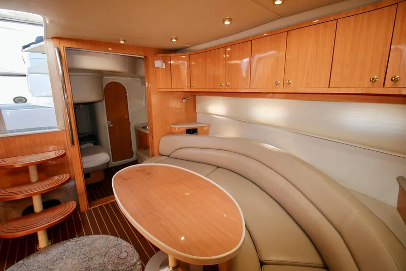 Slide: The Image of Luxurious interior of 2000 Regal Commodore 4160 yacht with wood cabinetry and curved seating. - 17
