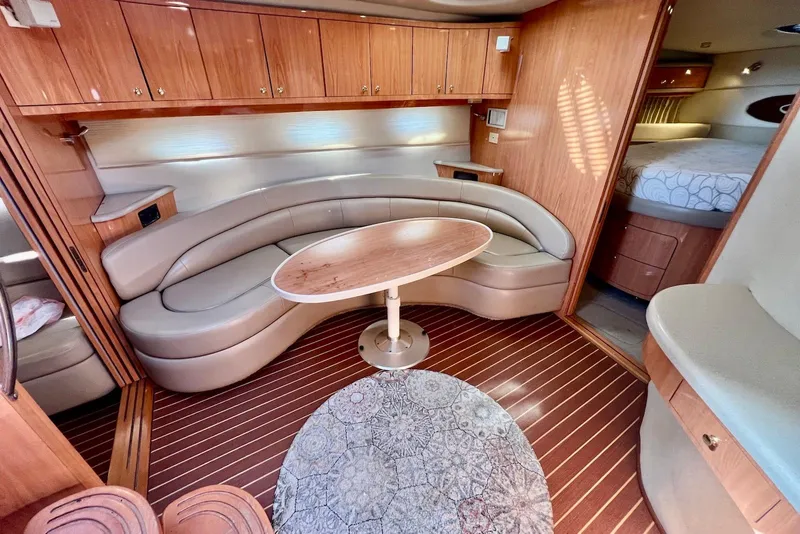 Slide: The Image of Luxurious interior of 2000 Regal Commodore 4160 yacht with curved seating and wooden finishes. - 20