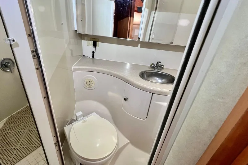 Slide: The Image of Compact bathroom in 2000 Regal Commodore 4160 yacht with sink, toilet, and mirror. - 26