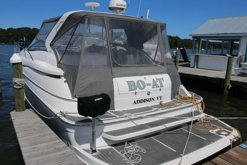 Slide: The Image of 2000 Regal Commodore 4160 boat docked, featuring covered deck and visible equipment. - 3