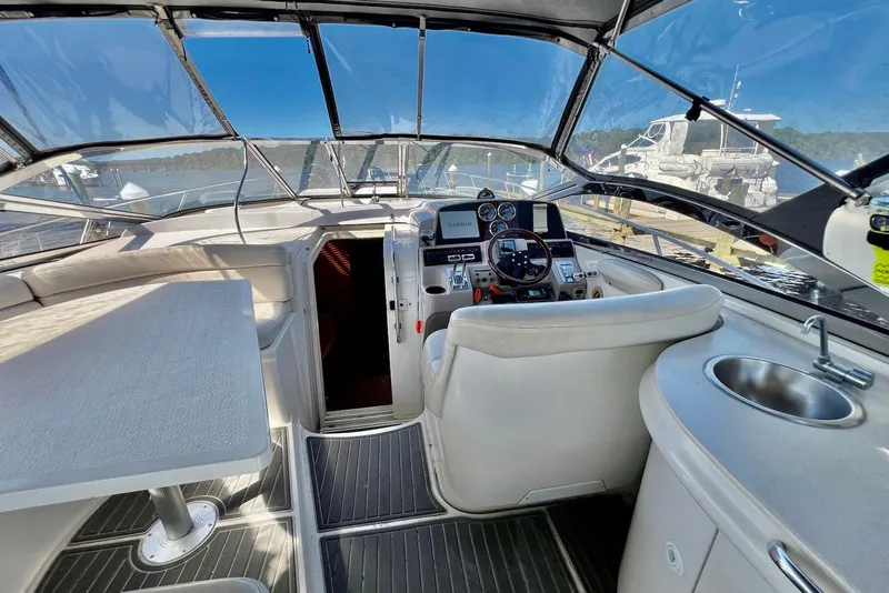 Slide: The Image of Interior of 2000 Regal Commodore 4160 yacht with helm, seating, and sink. - 4