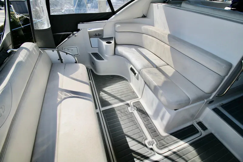 Slide: The Image of Interior seating of 2000 Regal Commodore 4160 yacht, featuring white cushioned benches. - 5