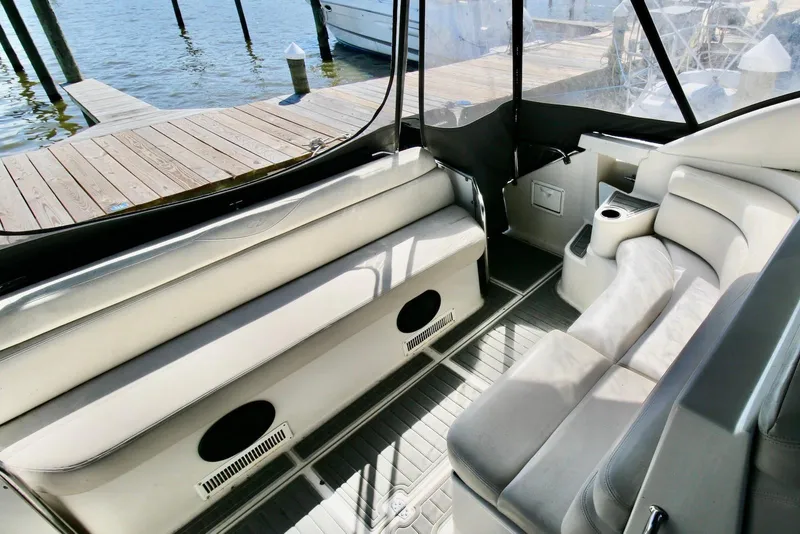Slide: The Image of Interior of 2000 Regal Commodore 4160 yacht with plush seating and dockside view. - 6