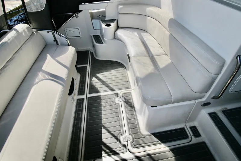 Slide: The Image of Interior seating of 2000 Regal Commodore 4160 boat, featuring white cushioned benches. - 7