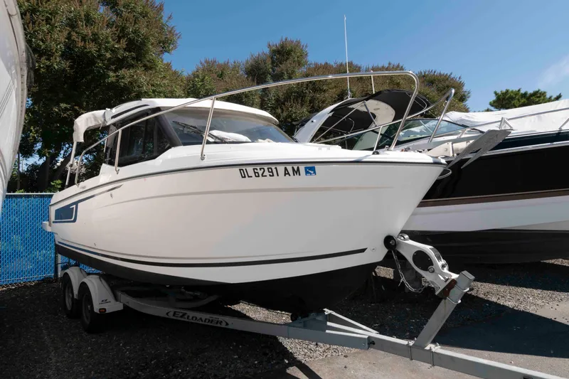 Slide: The Image of 2020 Jeanneau NC 695 boat on trailer, parked outdoors. - 1