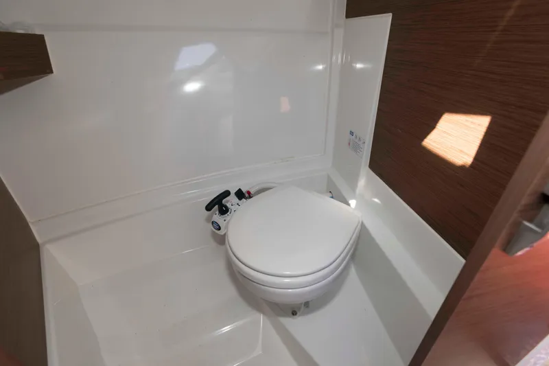 Slide: The Image of 2020 Jeanneau NC 695 boat bathroom with compact toilet and modern design. - 11