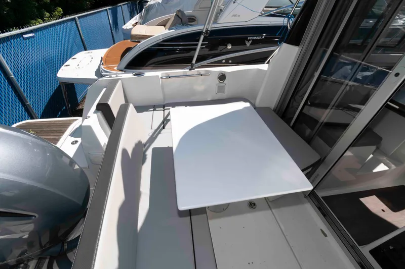 Slide: The Image of 2020 Jeanneau NC 695 boat interior with seating and table. - 4