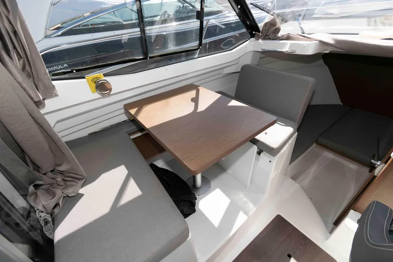 Slide: The Image of Interior of 2020 Jeanneau NC 695 boat with seating and wooden table. - 5