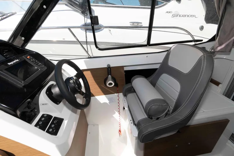 Slide: The Image of Interior helm of 2020 Jeanneau NC 695 boat with steering wheel and control panel. - 7