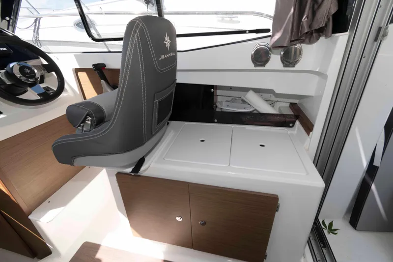 Slide: The Image of Interior of 2020 Jeanneau NC 695 boat with steering wheel and seating area. - 8