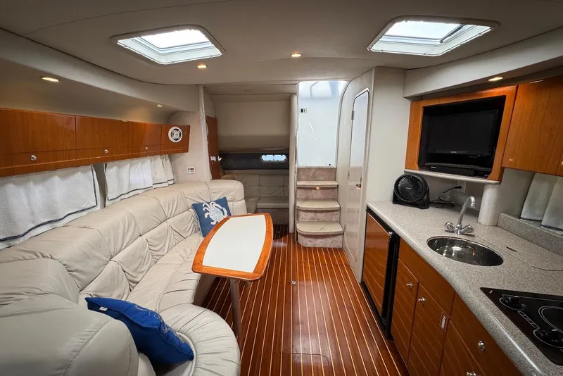 Slide: The Image of Luxurious interior of a 2002 Formula 37 Performance Cruiser with modern amenities and elegant design. - 12