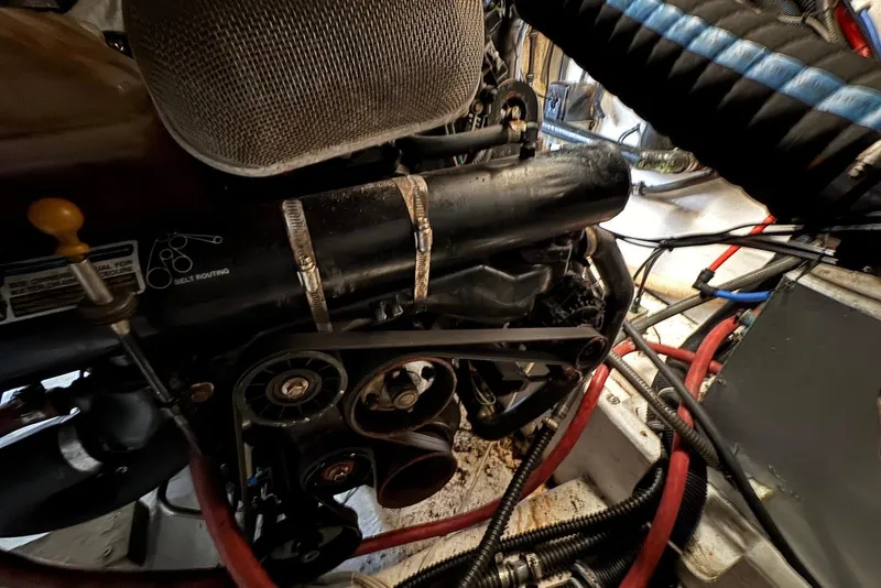 Slide: The Image of Engine compartment of a 2002 Formula 37 Performance Cruiser with visible belts and hoses. - 19