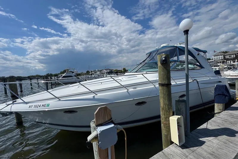 Slide: The Image of 2002 Formula 37 Performance Cruiser docked at marina under partly cloudy sky. - 2
