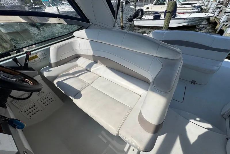 Slide: The Image of 2002 Formula 37 Performance Cruiser interior with white seating and helm, docked at marina. - 6