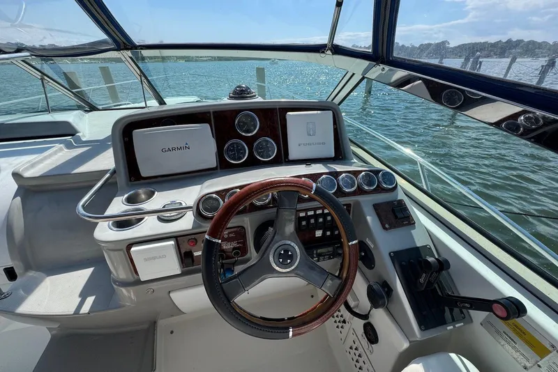 Slide: The Image of Cockpit of 2002 Formula 37 Performance Cruiser with Garmin navigation system, steering wheel, and controls. - 7