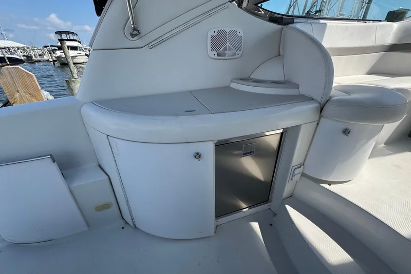 Slide: The Image of 2002 Formula 37 Performance Cruiser interior with seating and storage, docked at marina. - 8
