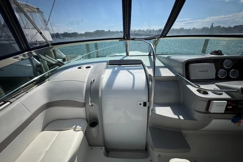Slide: The Image of 2002 Formula 37 Performance Cruiser cockpit with seating, navigation equipment, and waterfront view. - 9