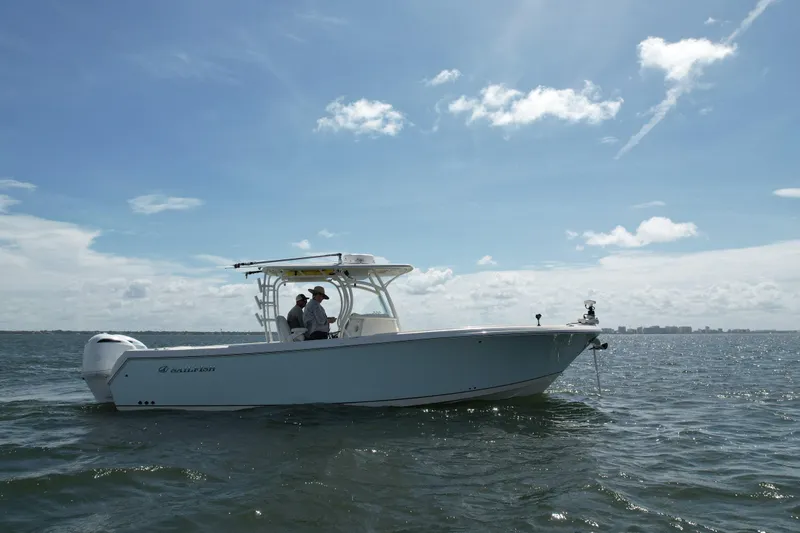 Slide: The Image of 2015 Sailfish 320 CC boat on open water under clear sky. - 1