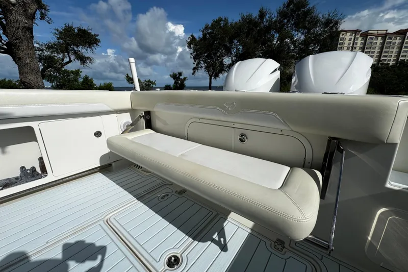 Slide: The Image of 2015 Sailfish 320 CC boat interior with foldable seating and dual engines. - 15
