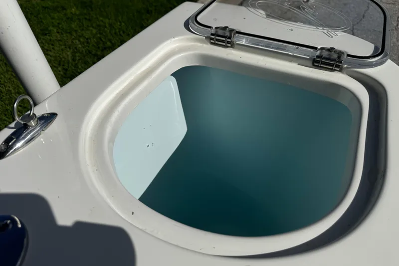 Slide: The Image of Open hatch on 2015 Sailfish 320 CC boat, showing interior compartment. - 17
