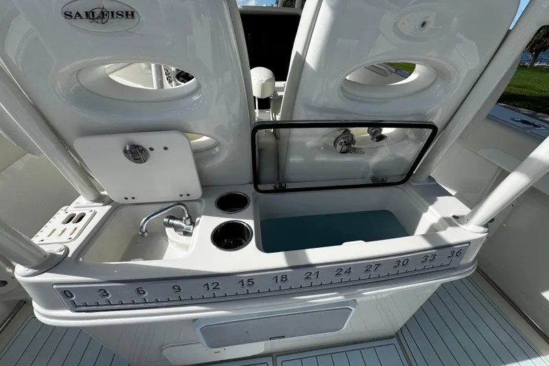 Slide: The Image of 2015 Sailfish 320 CC boat interior with sink, storage, and measuring scale. - 19