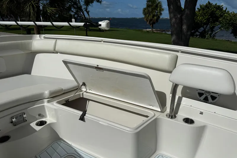 Slide: The Image of Open storage compartment on 2015 Sailfish 320 CC boat with seating and cup holders. - 26
