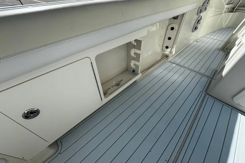 Slide: The Image of 2015 Sailfish 320 CC boat interior with storage compartment and sleek flooring. - 32