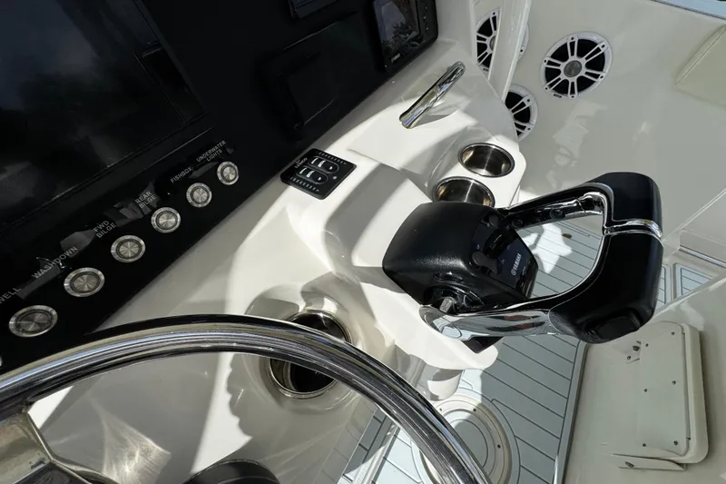 Slide: The Image of Control panel of 2015 Sailfish 320 CC boat with steering wheel and throttle. - 35