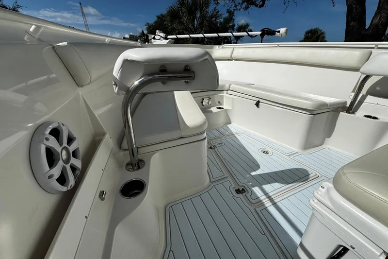 Slide: The Image of 2015 Sailfish 320 CC boat interior with seating, speaker, and rod holder. - 37