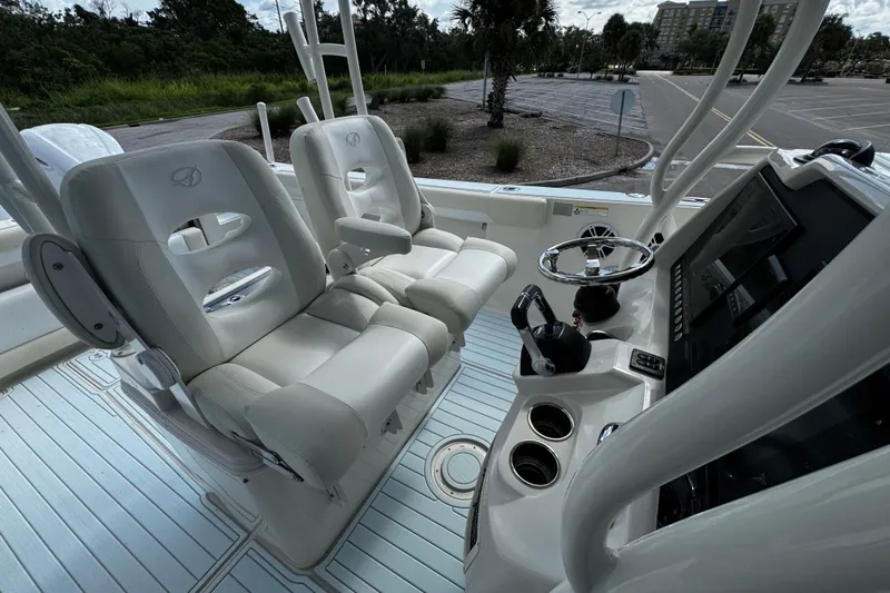 Slide: The Image of 2015 Sailfish 320 CC boat interior with dual seats and control panel. - 38