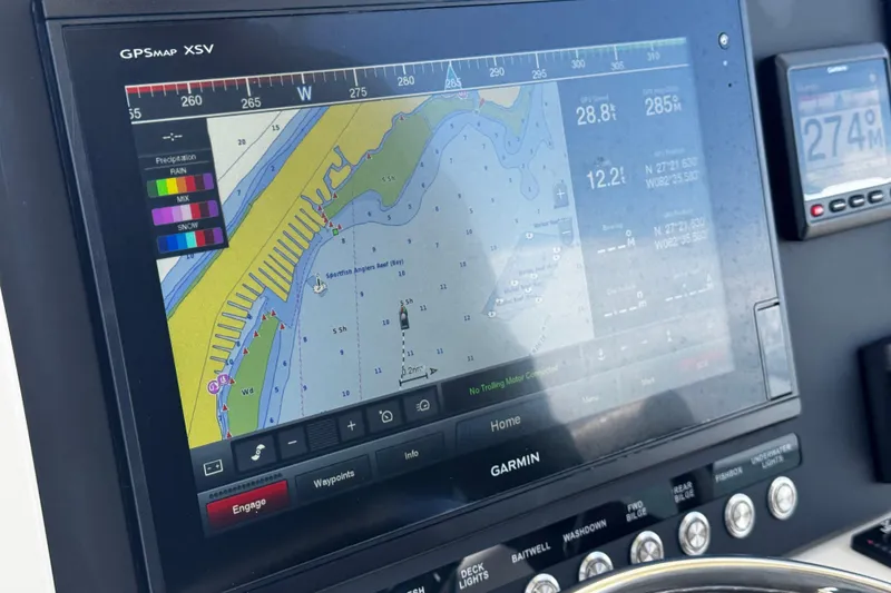 Slide: The Image of Garmin GPS display on 2015 Sailfish 320 CC boat, showing navigation and weather data. - 46