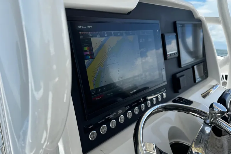 Slide: The Image of Control panel of 2015 Sailfish 320 CC boat with GPS navigation system. - 47