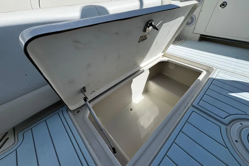 Slide: The Image of Open storage compartment on 2015 Sailfish 320 CC boat deck. - 48