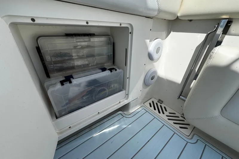 Slide: The Image of Storage compartment on 2015 Sailfish 320 CC boat with organized tackle boxes. - 49