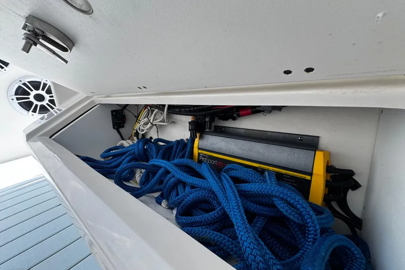 Slide: The Image of Storage compartment of 2015 Sailfish 320 CC boat with blue ropes and equipment. - 52